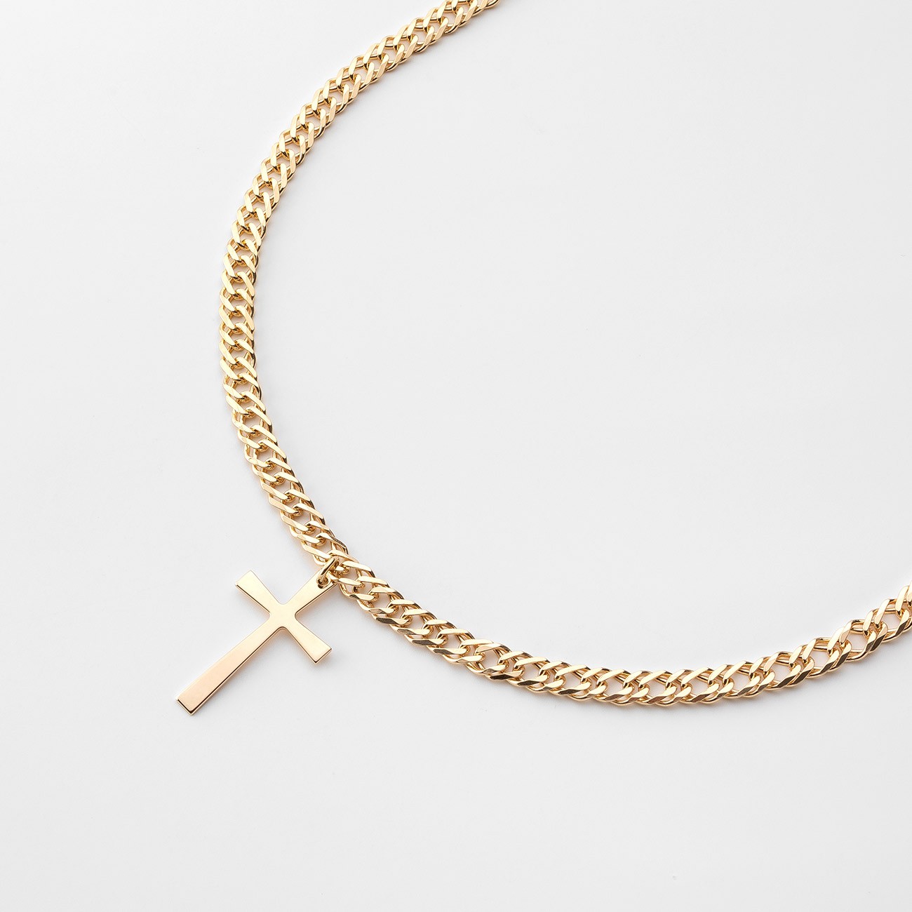 Cross pendant on a curb chain