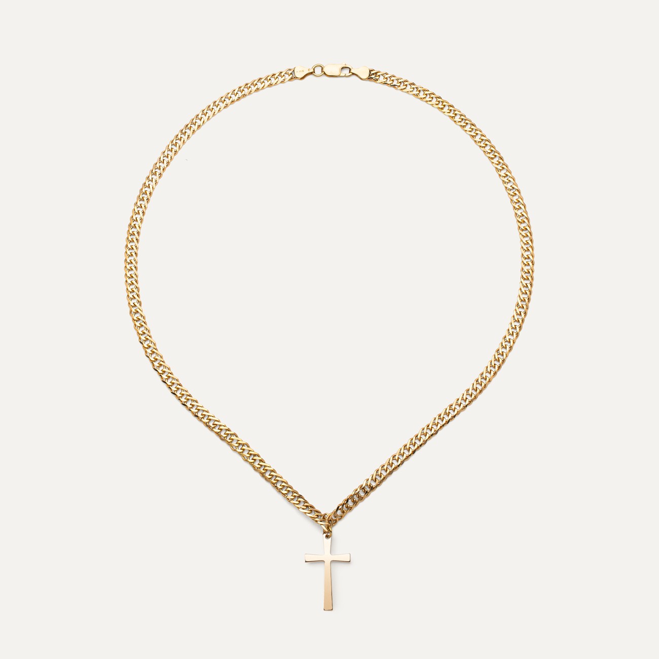Cross pendant on a curb chain