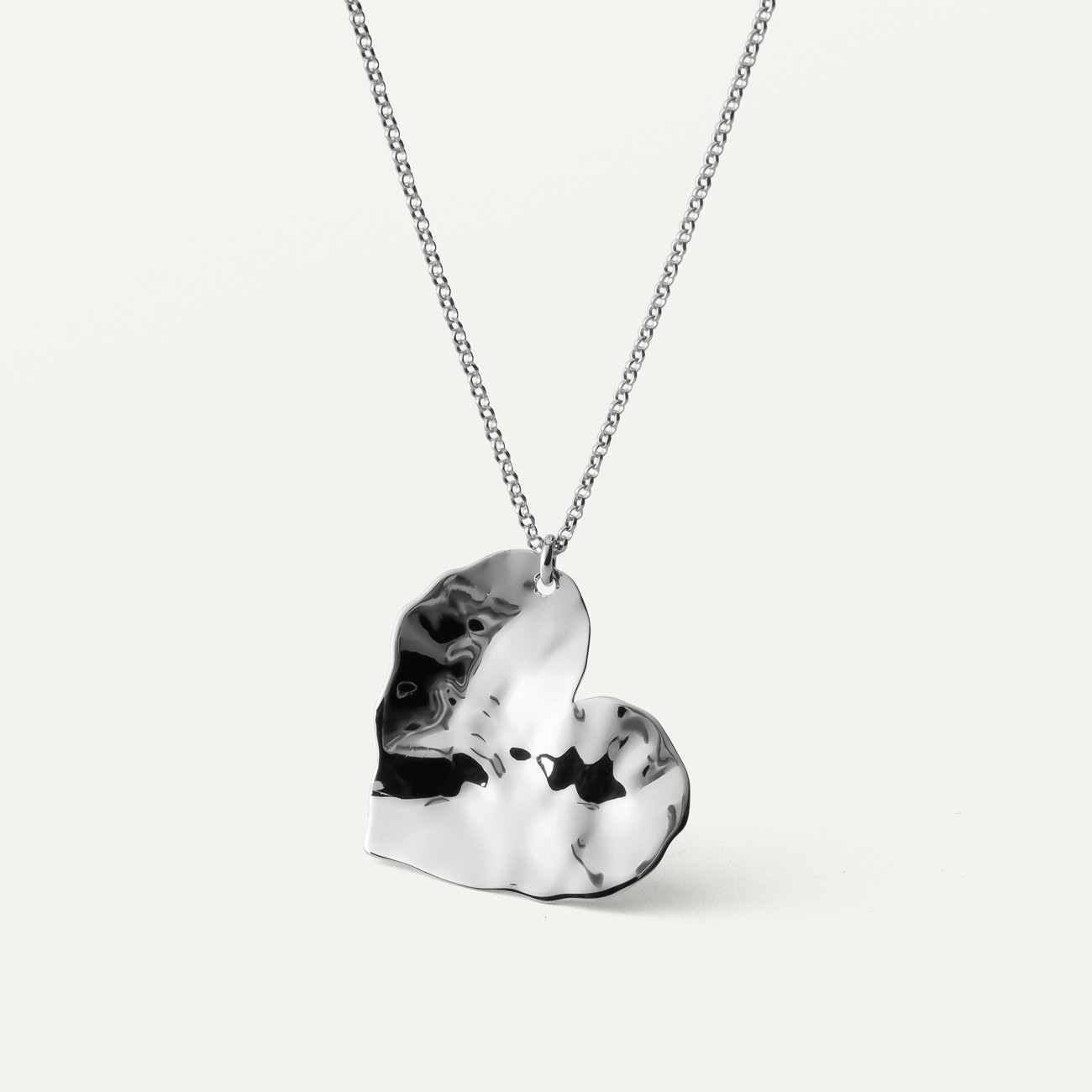 Silver necklace with a crushed heart plate