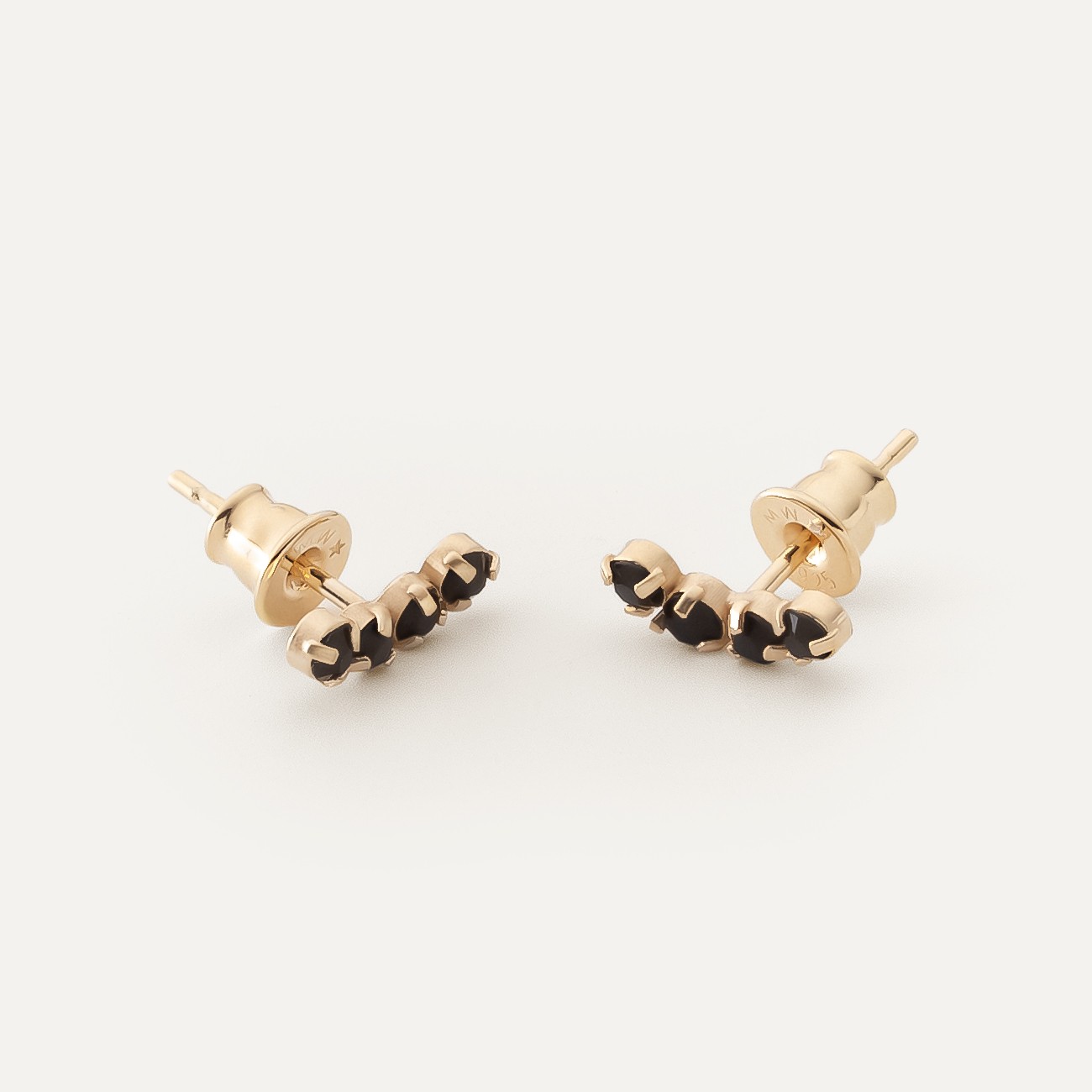 Earrings along the ear with black zircons gold plated