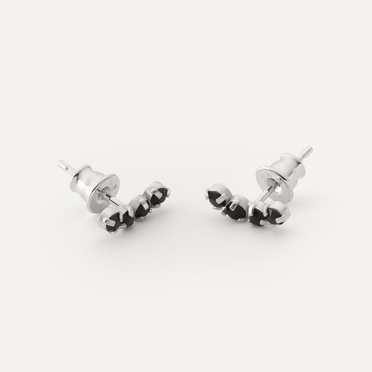 Earrings along the ear with black zircons platinum plated