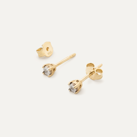 Gold stud earrings with a diamond